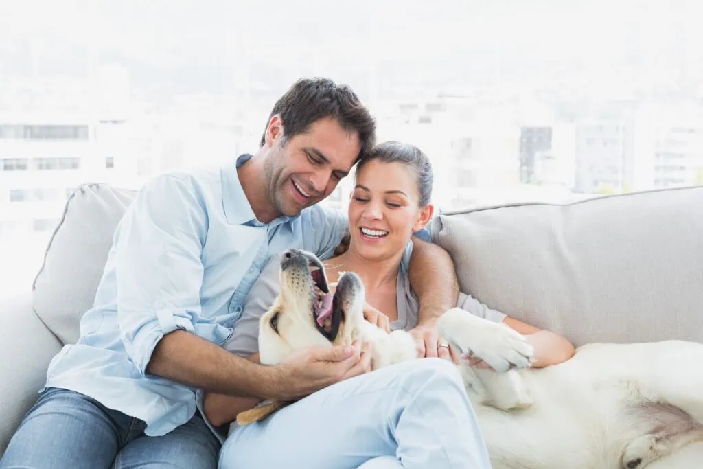 Happy couple with dog loving their new life after learning how to live in Edmonton.